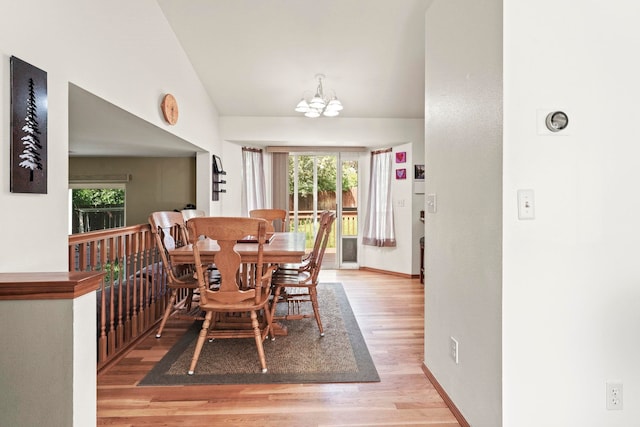 8115 E Sommerset Dr, Spokane, WA 99212 - dining space featuring a chandelier, healthy amount of natural light, light wood-type flooring, baseboards, and lofted ceiling