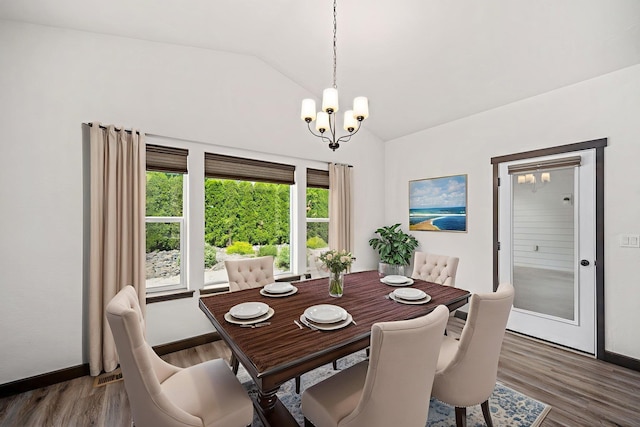 10697 N Crimson Dr, Hayden, ID 83835 - dining area featuring a chandelier, wood finished floors, high vaulted ceiling, and baseboards