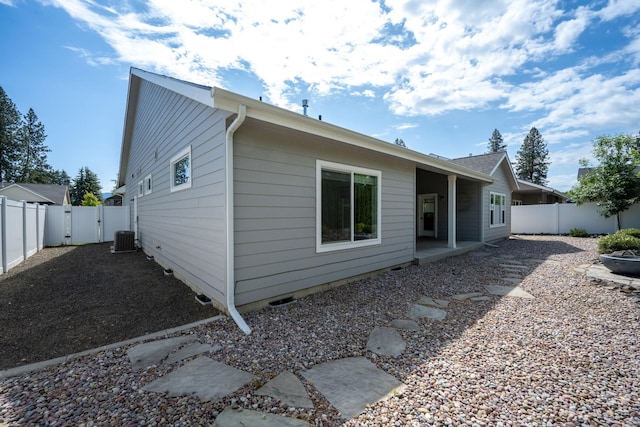 10697 N Crimson Dr, Hayden, ID 83835 - rear view of house with a fenced backyard, a gate, central AC unit, and a patio area
