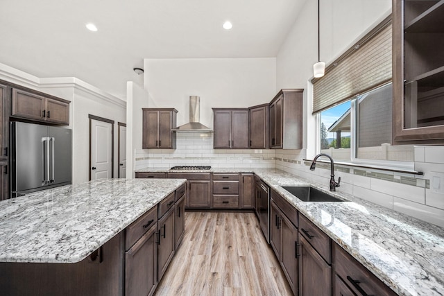 10697 N Crimson Dr, Hayden, ID 83835 - kitchen featuring stainless steel appliances, wall chimney range hood, a sink, light stone counters, and recessed lighting