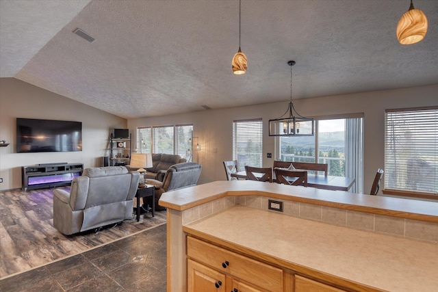 6930 N N Lynden Ln, Otis Orchards, WA 99027 - kitchen with a textured ceiling, hanging light fixtures, a chandelier, lofted ceiling, and open floor plan