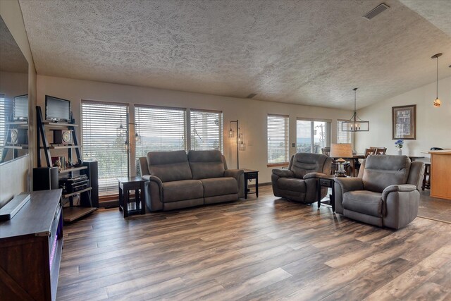 6930 N N Lynden Ln, Otis Orchards, WA 99027 - living area with a chandelier, a textured ceiling, wood finished floors, and vaulted ceiling