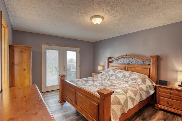 6930 N N Lynden Ln, Otis Orchards, WA 99027 - bedroom featuring dark wood finished floors, access to outside, and a textured ceiling