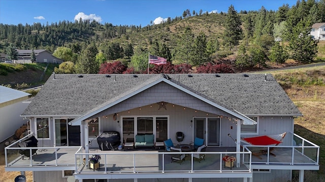 6930 N N Lynden Ln, Otis Orchards, WA 99027 - rear view of property with a deck with mountain view and a shingled roof
