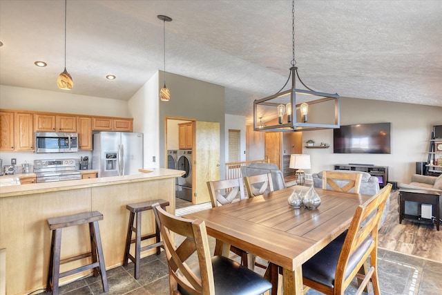 6930 N N Lynden Ln, Otis Orchards, WA 99027 - dining space with independent washer and dryer, lofted ceiling, a chandelier, and a textured ceiling