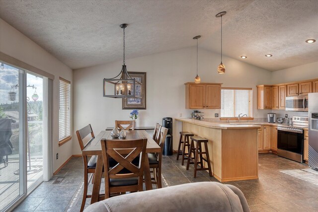 6930 N N Lynden Ln, Otis Orchards, WA 99027 - dining area featuring lofted ceiling, a textured ceiling, a chandelier, baseboards, and recessed lighting