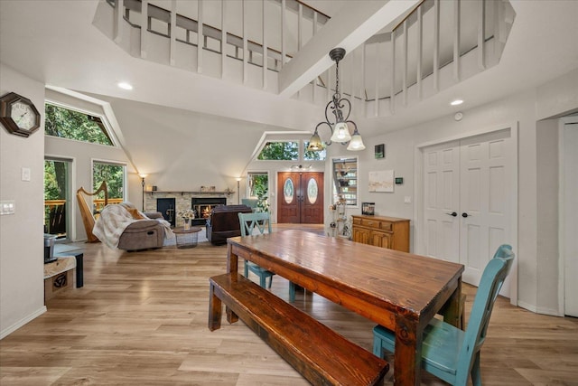 1411 W Spring Ln, Spokane, WA 99218 - dining area featuring a high ceiling, a stone fireplace, light wood finished floors, and recessed lighting