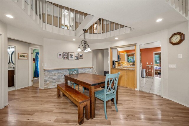1411 W Spring Ln, Spokane, WA 99218 - dining area with light wood-style floors, a chandelier, recessed lighting, and a towering ceiling