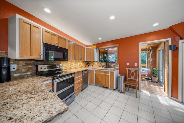 1411 W Spring Ln, Spokane, WA 99218 - kitchen with stainless steel appliances, tasteful backsplash, light tile patterned floors, recessed lighting, and light stone countertops