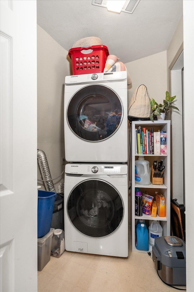 1411 W Spring Ln, Spokane, WA 99218 - laundry room with stacked washer / drying machine and tile patterned floors