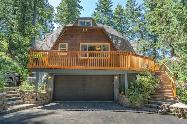 1411 W Spring Ln, Spokane, WA 99218 - view of front of house with roof with shingles, driveway, a garage, and stairway