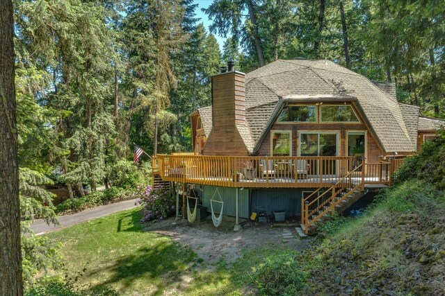 1411 W Spring Ln, Spokane, WA 99218 - back of property with stairway, a wooden deck, a chimney, roof with shingles, and a lawn