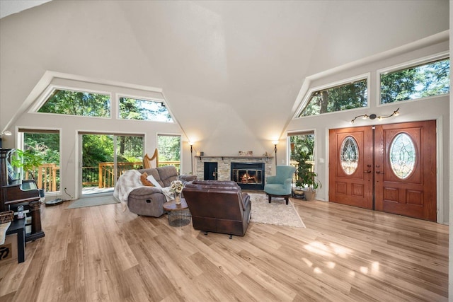 1411 W Spring Ln, Spokane, WA 99218 - living room featuring high vaulted ceiling, a fireplace, and wood finished floors