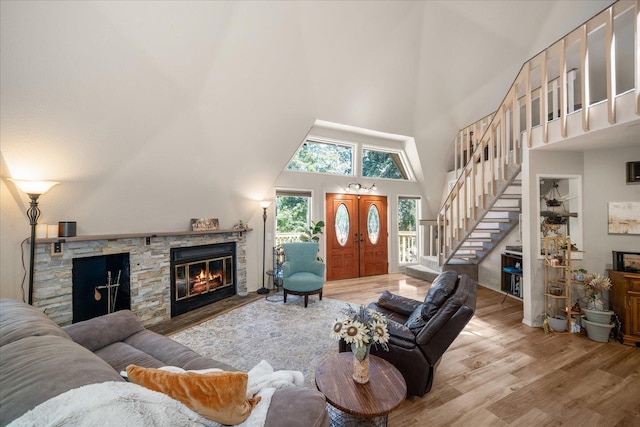 1411 W Spring Ln, Spokane, WA 99218 - living area with a fireplace, wood finished floors, stairs, and a towering ceiling