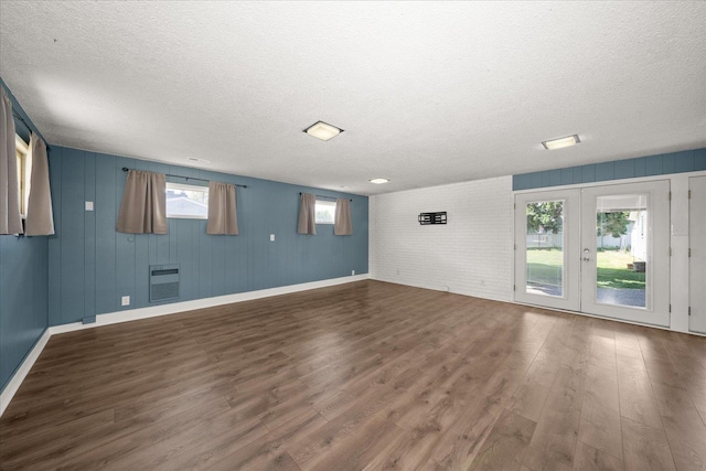519 N Bannen Rd, Spokane Valley, WA 99216 - spare room with a textured ceiling, dark wood-style flooring, heating unit, baseboards, and french doors