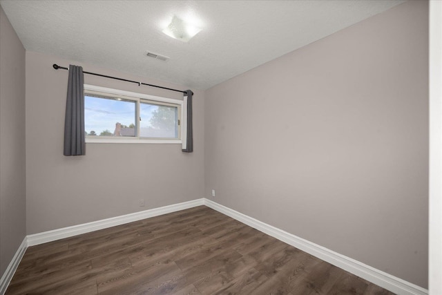 519 N Bannen Rd, Spokane Valley, WA 99216 - spare room featuring dark wood-style floors, baseboards, and a textured ceiling