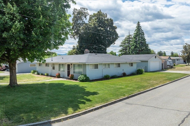 519 N Bannen Rd, Spokane Valley, WA 99216 - single story home with concrete driveway, a front lawn, a detached garage, and an outdoor structure