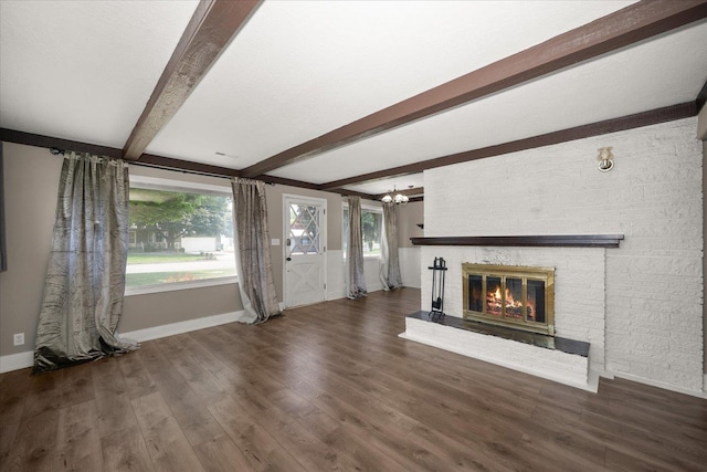 519 N Bannen Rd, Spokane Valley, WA 99216 - unfurnished living room with beam ceiling, baseboards, a brick fireplace, a chandelier, and wood finished floors