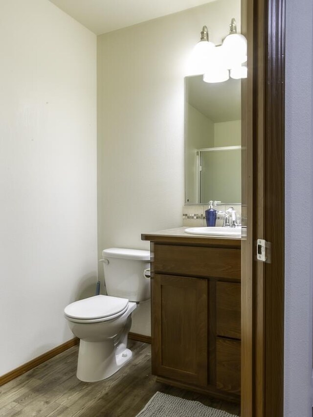 9705 E 4th Ave Unit 9707, Spokane Valley, WA 99206 - bathroom with wood finished floors, vanity, toilet, and baseboards