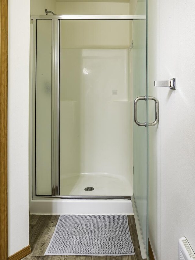 9705 E 4th Ave Unit 9707, Spokane Valley, WA 99206 - bathroom featuring wood finished floors and a stall shower