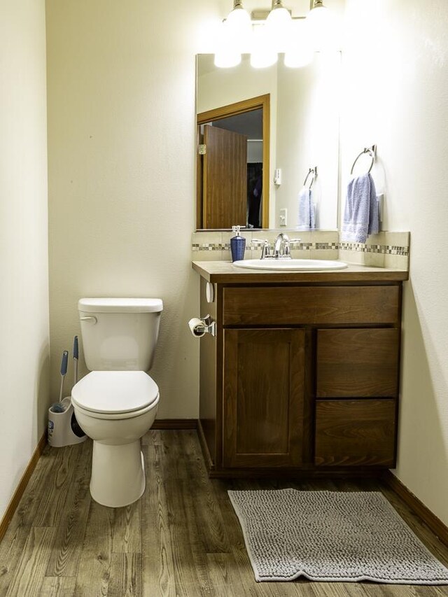 9705 E 4th Ave Unit 9707, Spokane Valley, WA 99206 - bathroom featuring vanity, wood finished floors, toilet, and baseboards