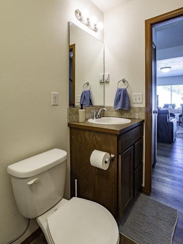 9705 E 4th Ave Unit 9707, Spokane Valley, WA 99206 - half bath with toilet, wood finished floors, and vanity