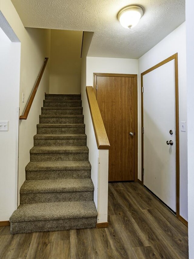 9705 E 4th Ave Unit 9707, Spokane Valley, WA 99206 - stairway with wood finished floors and a textured ceiling