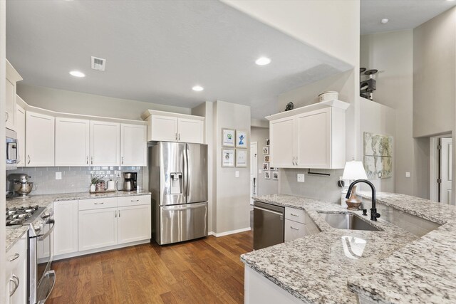 13616 W Pine Bluff Rd, Nine Mile Falls, WA 99026 - kitchen with stainless steel appliances, a sink, white cabinetry, backsplash, and recessed lighting