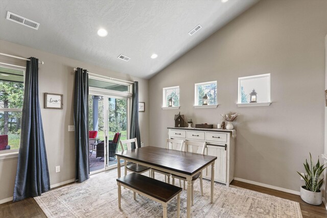 13616 W Pine Bluff Rd, Nine Mile Falls, WA 99026 - dining room featuring wood finished floors, recessed lighting, healthy amount of natural light, lofted ceiling, and baseboards