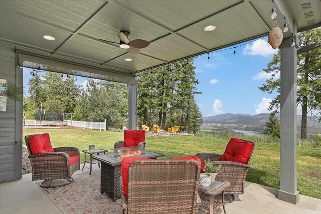 13616 W Pine Bluff Rd, Nine Mile Falls, WA 99026 - view of patio / terrace with a mountain view, a trampoline, and a ceiling fan