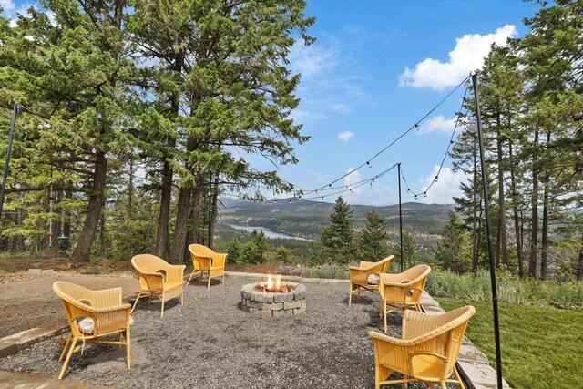 13616 W Pine Bluff Rd, Nine Mile Falls, WA 99026 - view of patio with an outdoor fire pit and a water view