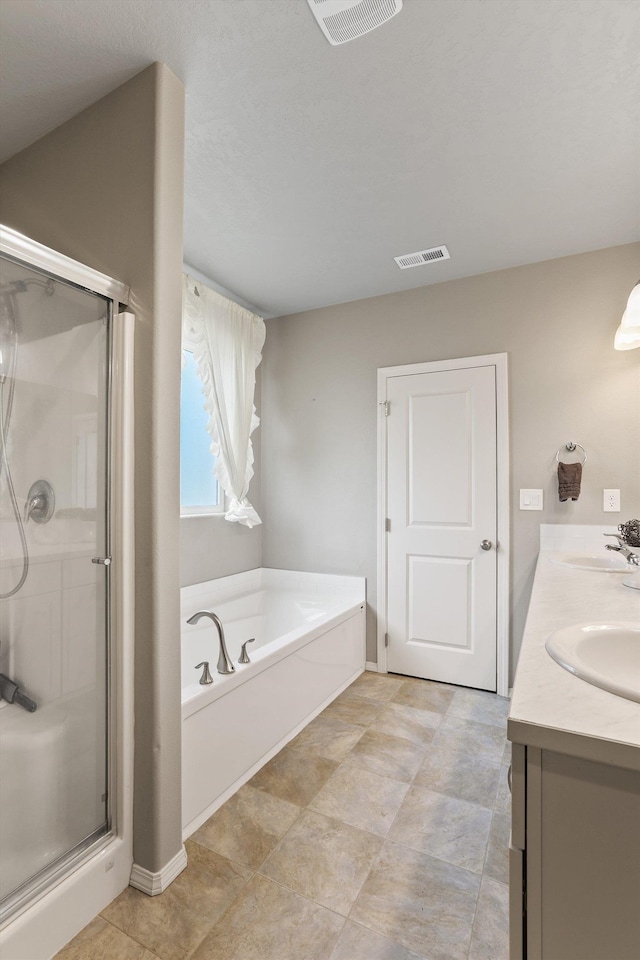 13616 W Pine Bluff Rd, Nine Mile Falls, WA 99026 - bathroom with a shower stall, a garden tub, double vanity, and baseboards