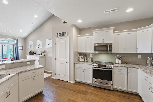13616 W Pine Bluff Rd, Nine Mile Falls, WA 99026 - kitchen with stainless steel appliances, white cabinetry, backsplash, wood finished floors, and light stone counters