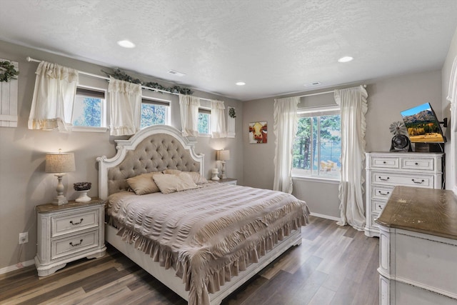 13616 W Pine Bluff Rd, Nine Mile Falls, WA 99026 - bedroom with multiple windows, baseboards, wood finished floors, a textured ceiling, and recessed lighting