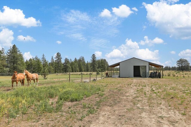 13616 W Pine Bluff Rd, Nine Mile Falls, WA 99026 - view of yard with a view of rural / pastoral area, an outbuilding, an exterior structure, and a garage