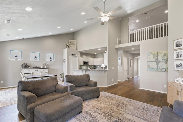 13616 W Pine Bluff Rd, Nine Mile Falls, WA 99026 - living room with dark wood-style floors, ceiling fan, baseboards, high vaulted ceiling, and recessed lighting