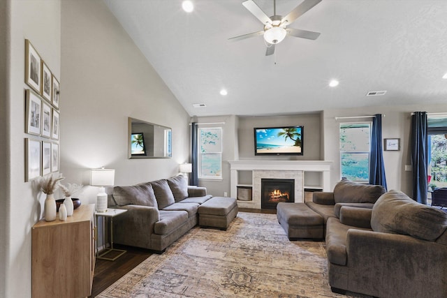 13616 W Pine Bluff Rd, Nine Mile Falls, WA 99026 - living room featuring recessed lighting, wood finished floors, a tiled fireplace, lofted ceiling, and ceiling fan