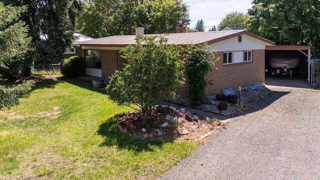 6721 N Howard St, Spokane, WA 99208 - view of front of home with brick siding, a front yard, gravel driveway, and a metal roof