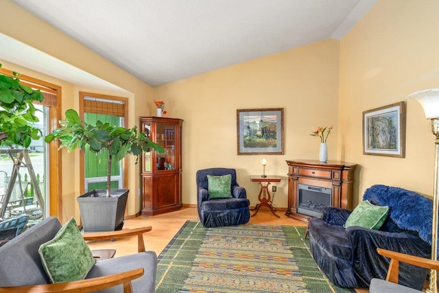 23823 E Garland Ave, Otis Orchards, WA 99027 - living area featuring vaulted ceiling, wood finished floors, and a fireplace
