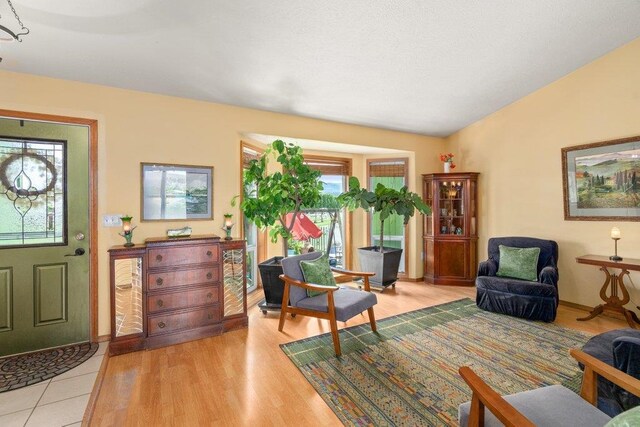 23823 E Garland Ave, Otis Orchards, WA 99027 - living area with light wood finished floors, lofted ceiling, and baseboards