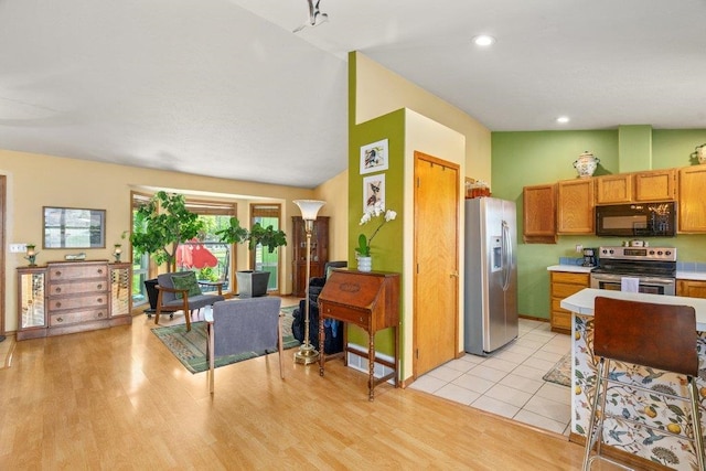 23823 E Garland Ave, Otis Orchards, WA 99027 - kitchen with appliances with stainless steel finishes, light countertops, light wood-style floors, brown cabinetry, and recessed lighting