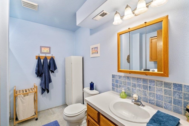 23823 E Garland Ave, Otis Orchards, WA 99027 - bathroom with tasteful backsplash, vanity, and toilet