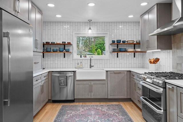 4318 S Magnolia St, Spokane, WA 99203 - kitchen featuring appliances with stainless steel finishes, wall chimney range hood, a sink, open shelves, and recessed lighting
