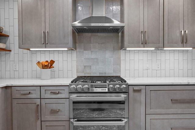4318 S Magnolia St, Spokane, WA 99203 - kitchen featuring stainless steel gas range oven, wall chimney exhaust hood, decorative backsplash, open shelves, and light stone counters