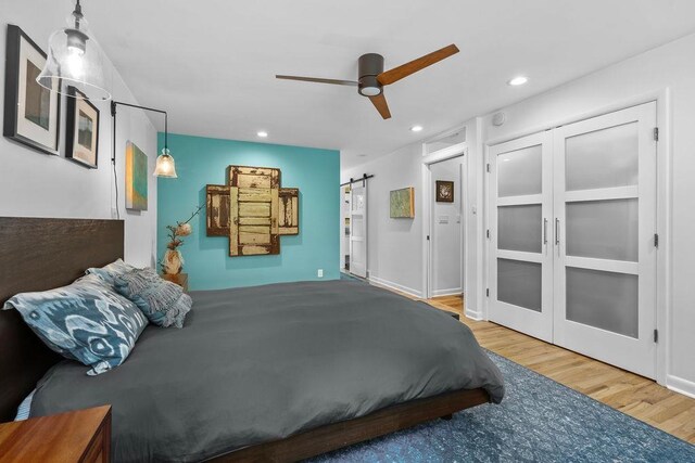 4318 S Magnolia St, Spokane, WA 99203 - bedroom featuring a barn door, wood finished floors, recessed lighting, french doors, and a ceiling fan