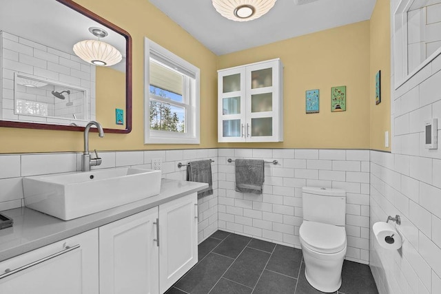 4318 S Magnolia St, Spokane, WA 99203 - full bathroom featuring tile walls, tile patterned flooring, toilet, vanity, and wainscoting