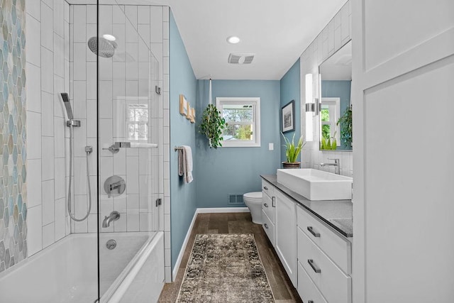 4318 S Magnolia St, Spokane, WA 99203 - full bathroom featuring vanity, baseboards, toilet, shower / washtub combination, and wood finished floors