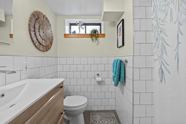 4318 S Magnolia St, Spokane, WA 99203 - bathroom with tile walls, vanity, toilet, tile patterned flooring, and wainscoting