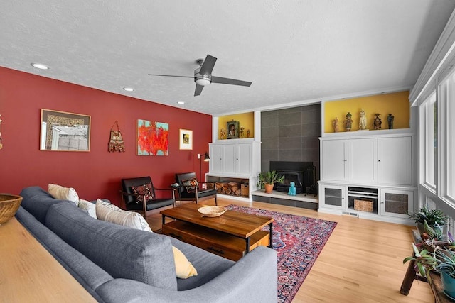 4318 S Magnolia St, Spokane, WA 99203 - living area featuring ceiling fan, wood finished floors, recessed lighting, a textured ceiling, and a tile fireplace