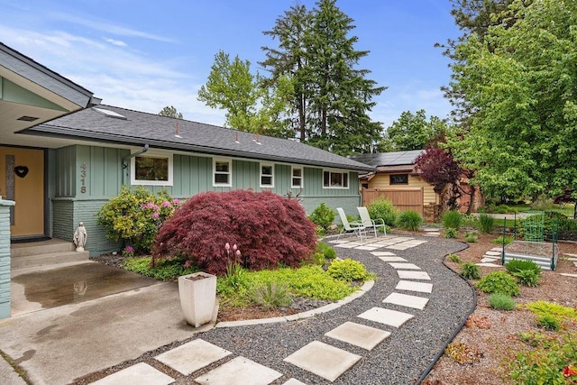 4318 S Magnolia St, Spokane, WA 99203 - view of front of house with board and batten siding, brick siding, a patio, and a shingled roof